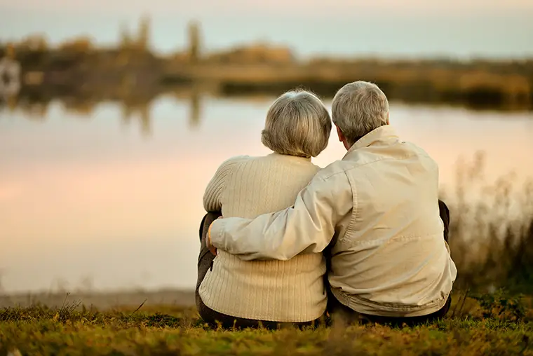 view of senior couple looking at the water annuities